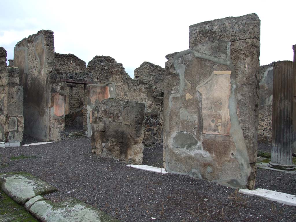 VI.7.20 Pompeii. December 2006. Looking north-west to two doorways linking the atrium with VI.7.21, on the right.
On the left is the entrance to the corridor leading to the rear of the house.
