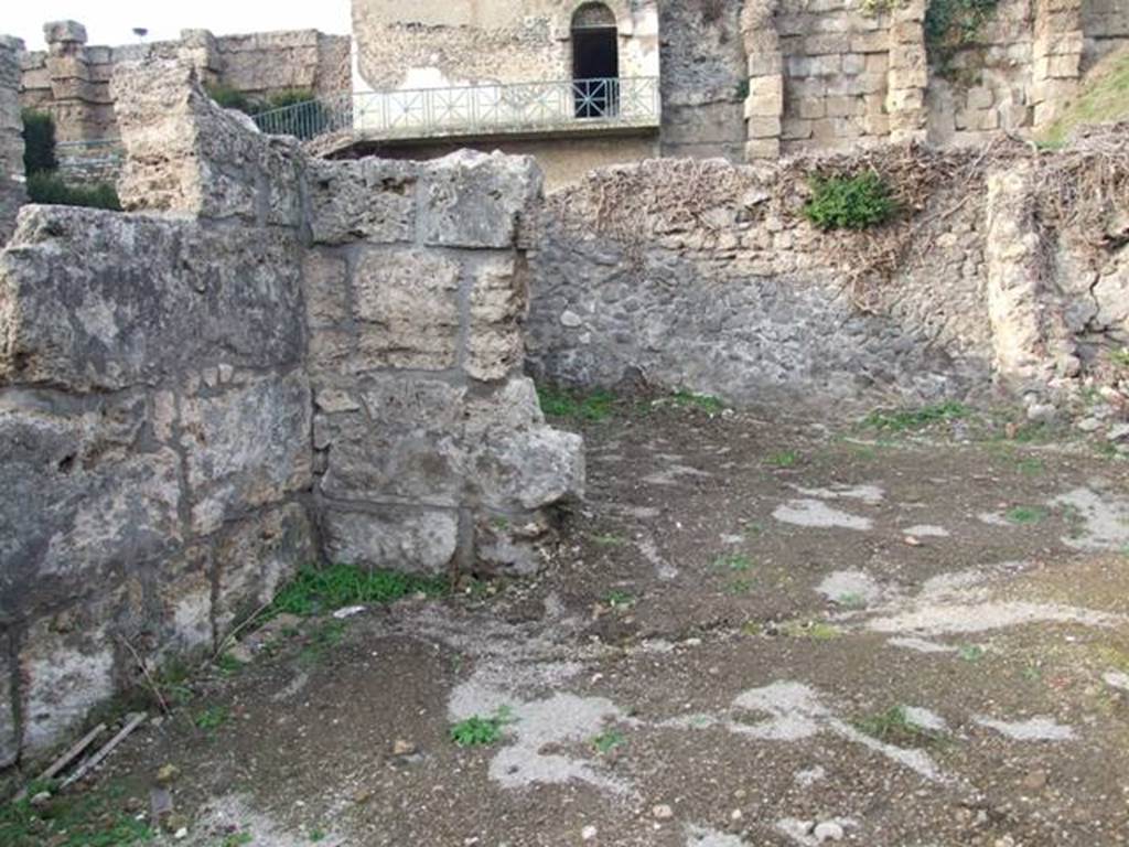 VI.9.1 Pompeii. December 2007.  Looking across site of room 14 towards the kitchen, room 13 in north-west corner. Looking north from near entrance.
According to Fiorelli, this area would have been the site of a storeroom and kitchen and latrine.
According to Warscher, the room “b” (our room 14) had a low level and in front of the door into the kitchen, there was a tufa step. 
See Warscher, T, 1938: Codex Topographicus Pompejanus, Regio VI, insula 9: Pars prima, Rome, DAIR.   

