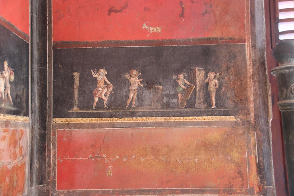 VI.15.1 Pompeii. October 2024. 
South wall in south-east corner with painting of cupids taking part in an archery or throwing contest. Photo courtesy of Klaus Heese.
