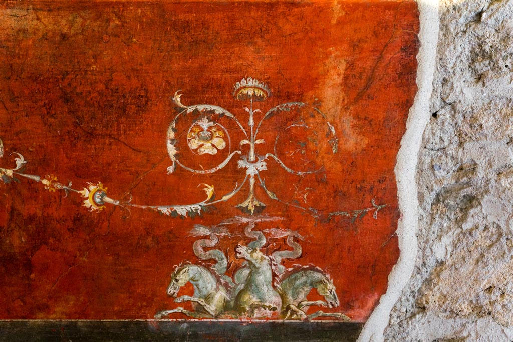 VI.15.1 Pompeii. March 2023. 
Detail of painted decoration below central painting on south wall of exedra. Photo courtesy of Johannes Eber.
