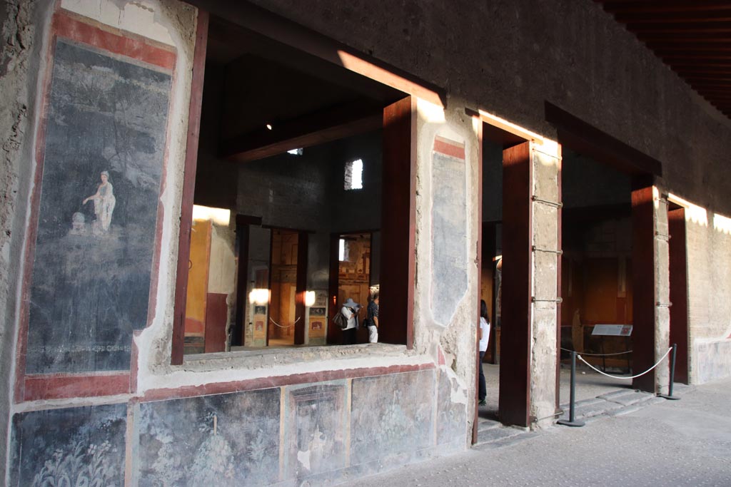 VI.15.1 Pompeii. October 2023. 
Looking along east portico towards wall and window of north ala, on left, and entrance to atrium, on right. Photo courtesy of Klaus Heese.
