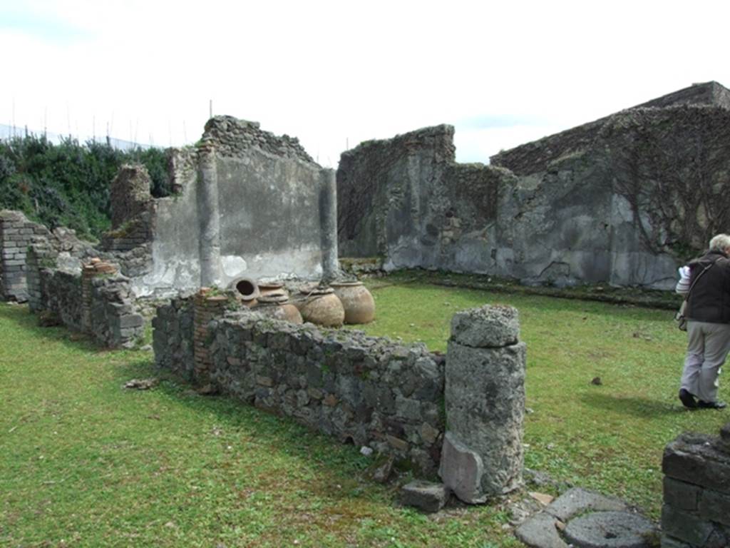 VI.16.27 Pompeii. March 2009. Looking south-east across north portico to peristyle garden M. A group of clay pots can be seen in the north-east corner.
