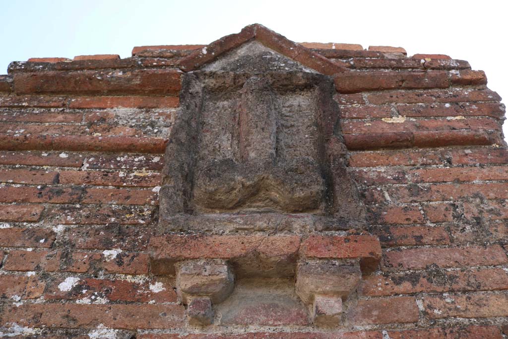 VI.17.3/4 Pompeii December 2018. 
Looking west to plaque on pilaster between VI.17.4 and VI.17.3. Photo courtesy of Aude Durand.

