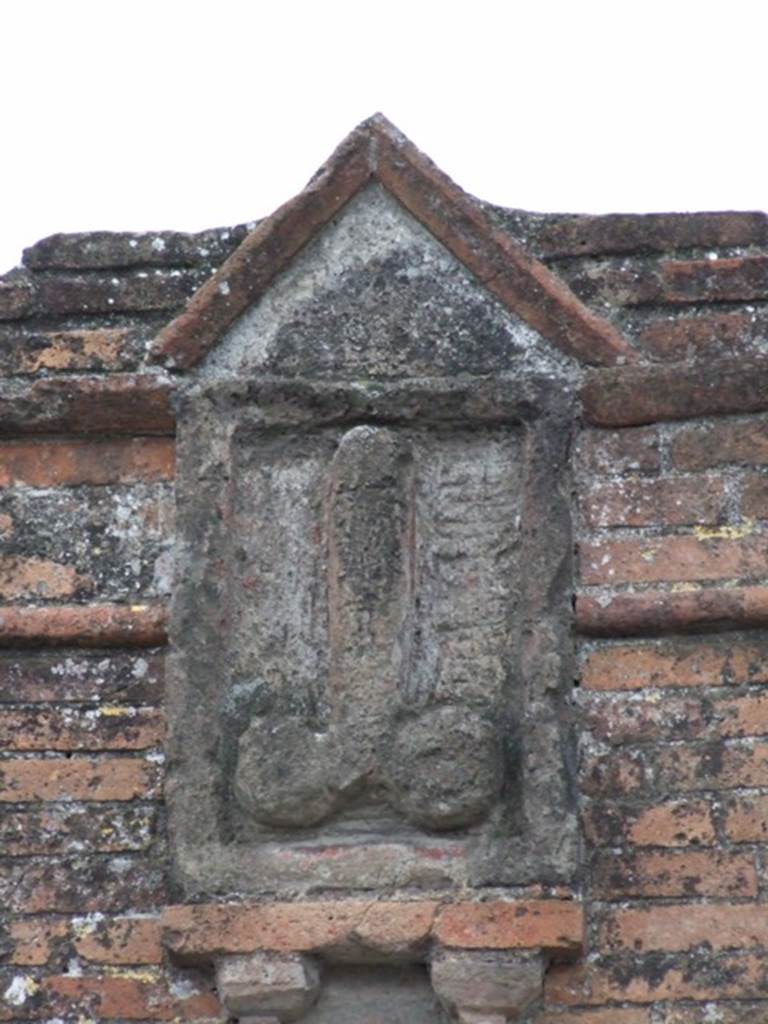 VI.17.4 Pompeii. December 2007. Plaque with phallus on pillar between VI.17.4 and VI.17.3.