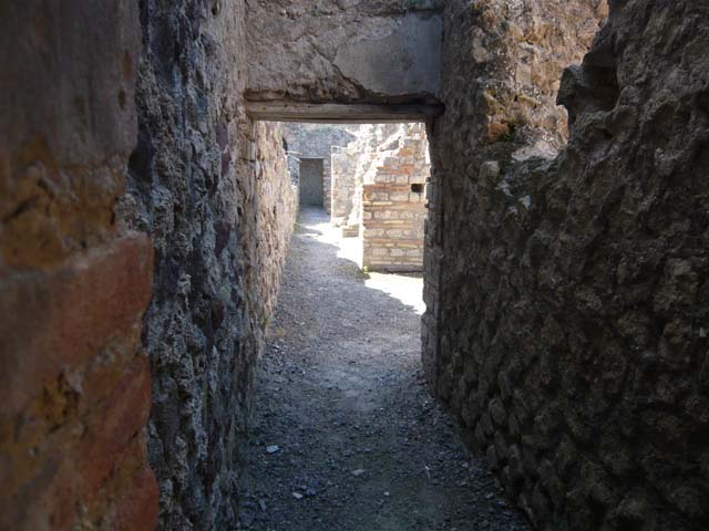 VII.1.8 Pompeii. December 2006. Corridor linking the rear of shops VII.1.52 to VII.1.58. Underneath is the start of an underground corridor running from room U.
