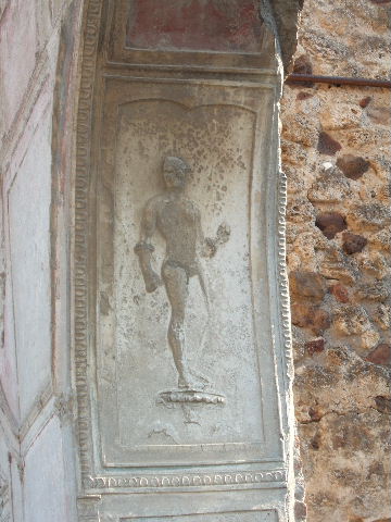 VII.1.8 Pompeii. September 2005. Nymphaeum F, east wall. Decorative stucco plasterwork figure on south side of arch.