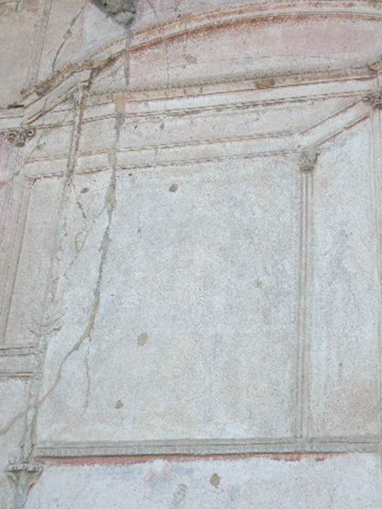 VII.1.8. Pompeii. September 2005.   Detail of plaster on wall in south west corner of gymnasium C.  
