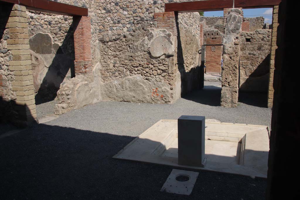 VI.1.25 Pompeii. September 2017. 
Looking north-east across impluvium in atrium 24 to fauces 23 and entrance VII.1.25. Photo courtesy of Klaus Heese.

