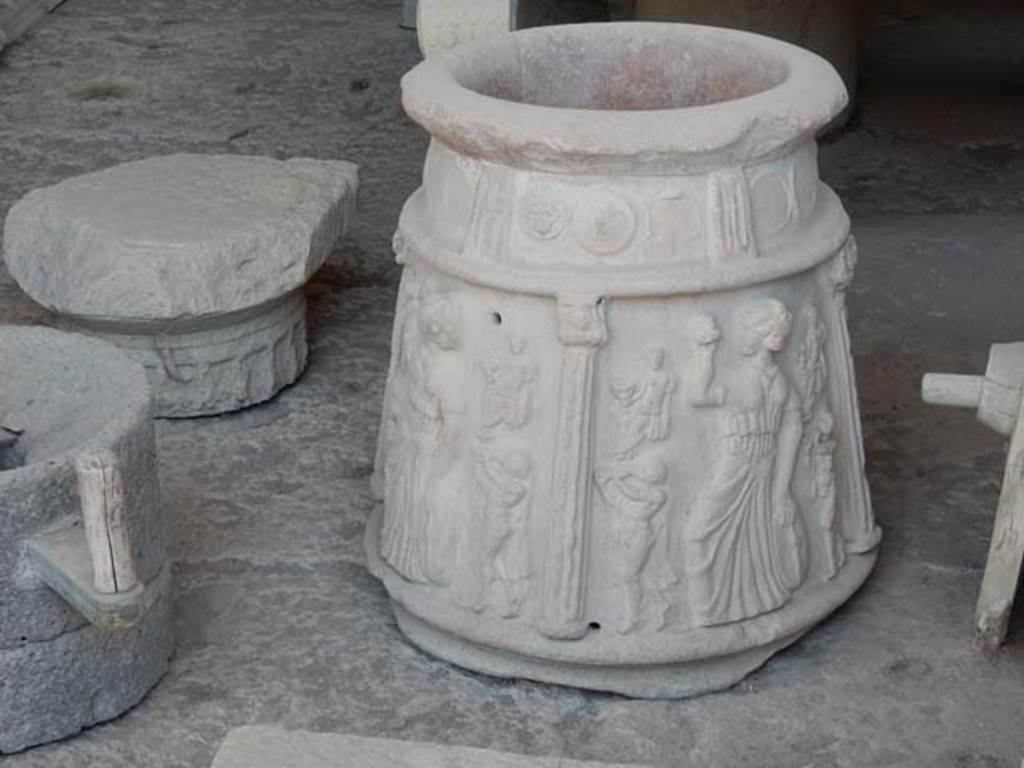 VII.7.29 Pompeii. September 2015. Terracotta puteal (from I.13.8?) with moulded decoration of columns and Bacchic figures in storage.
According to Roberts,
there are three scenes divided by columns each showing a Maenad with tambourine and castanets with seated figures, perhaps Bacchus, and satyrs playing the twin pipes (auloi).
See Roberts, P., 2013. Life and Death in Pompeii and Herculaneum. London: British Museum Press, p. 153, fig. 167.
PAP inventory number 44908.
Photo courtesy of Buzz Ferebee.
