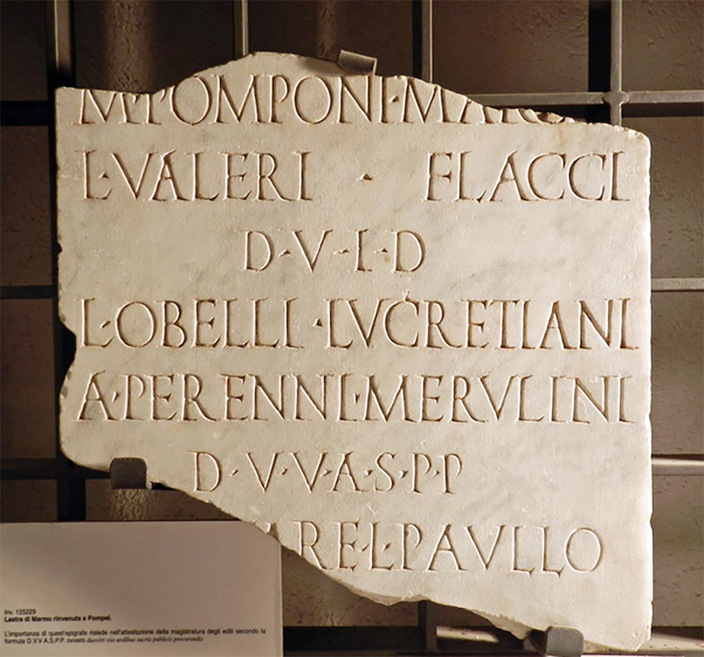 VII.8.1 Pompeii. Tablet found in 1900. Actions taken by decree of the decurions and by order of the duoviri and Aediles.
Now in Naples Archaeological Museum. Inventory number 125229. 
According to the Epigraphic Database Roma this reads: -
------
M(arci) Pomponi Marc̣ẹ[ll(i),]
L(uci) Valeri Flacci
d(uum)v(irorum) i(ure) d(icundo),
L(uci) Obelli Lucretiani,
A(uli) Perenni Merulini
d(uum)v(irorum) v(iis) a(edibus) s(acris) p(ublicis) p(rocurandis),
[C(aio) Cae]ṣạre, L(ucio) Paullo
[co(n)s(ulibus).]       (AE 1901, 80)

The Naples Museum information card translates this as: -
“(By order of) Marcus Pomponius Marcellus and Lucius Valerius Flaccus, duoviri with judicial powers, Lucius Obellius
Lucretianus and Aulus Perennius Merulinus duoviri v.a.s.p.p. during the consulate of Gaius Caesar and Lucius Paullus”.       
