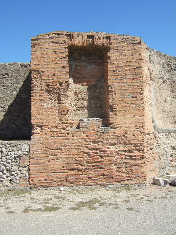 VII.9.1 Pompeii. May 2015. Portico 1. North end. Plaque to Romulus, son of Mars, situated below niche between entrance and apsidal niche 4. Photo courtesy of Buzz Ferebee.

