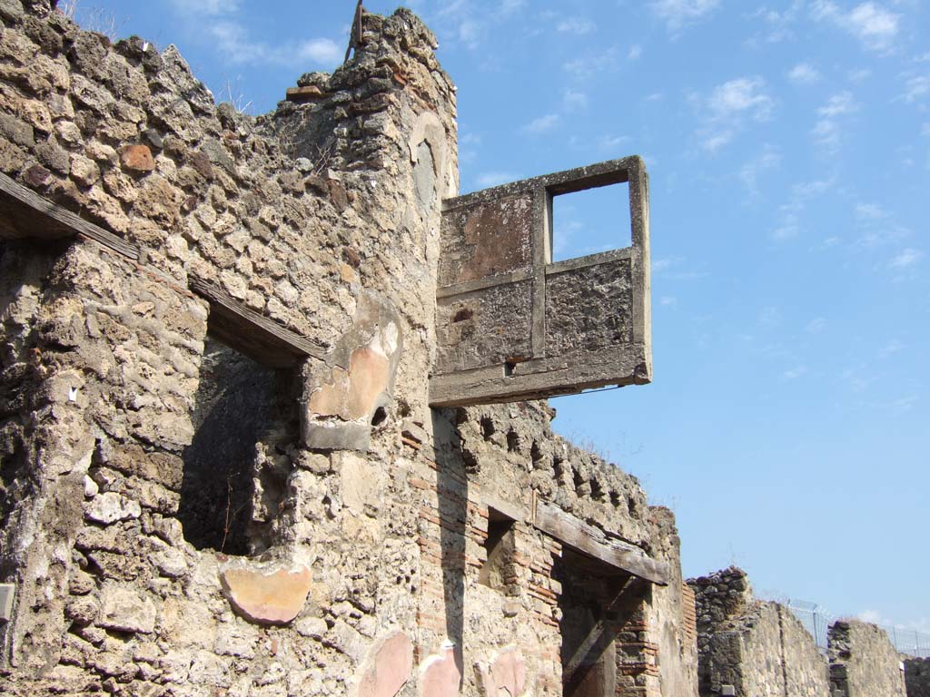 VII.15.5 Pompeii. September 2005. Looking east towards the west exterior wall of the “hanging” balcony with holes for support beams.