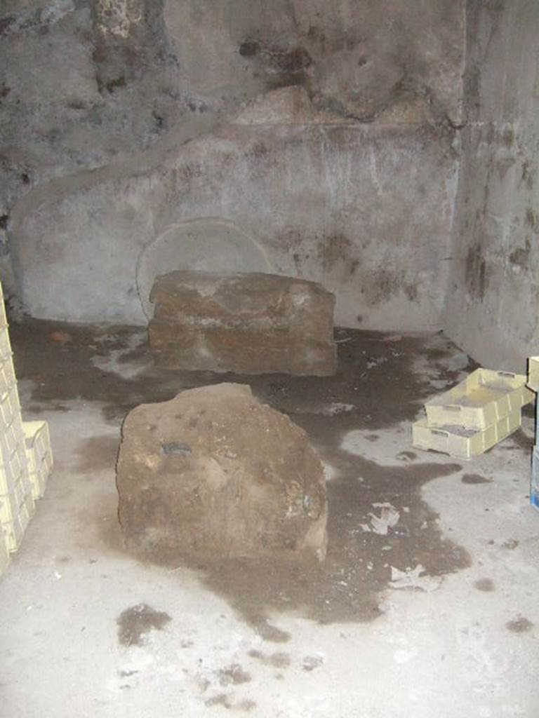 VII.15.16 Pompeii. May 2006. Room O, kneading room on south side of oven, looking east.
In the centre of the room are two masonry supports for a large work-table.
The walls would have had a high (1.60cm) red zoccolo and the wall above would have been painted white.

