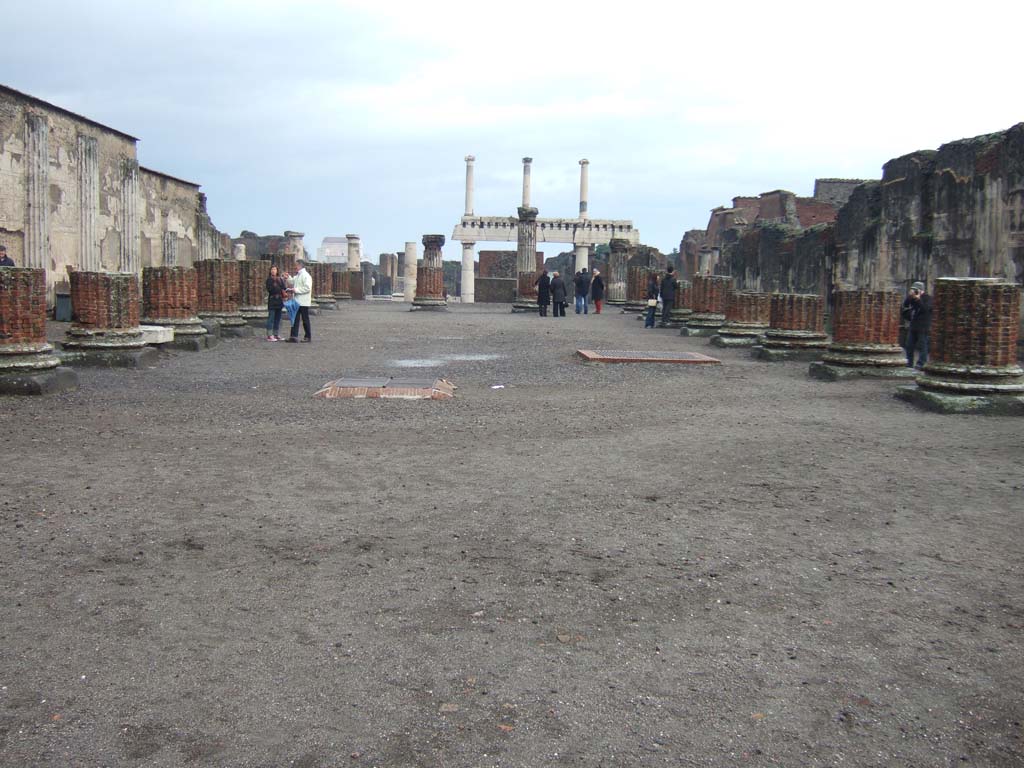 VIII.1.1 Pompeii. December 2005. Basilica, looking east along main central room.
Note, in the background, the three columns on top of four columns in the Forum.
