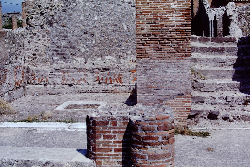 VIII.2.16 Pompeii. 1968. Looking from north portico towards triclinium with shallow marble basin/tub and steps to upper floor. 
On the wall zoccolo of the triclinium, large fragments of ceramics embedded in the rough plaster can be seen, which were the marks from the marble slabs used as cladding. Photo by Stanley A. Jashemski.
Source: The Wilhelmina and Stanley A. Jashemski archive in the University of Maryland Library, Special Collections (See collection page) and made available under the Creative Commons Attribution-Non-Commercial License v.4. See Licence and use details.
J68f1183
