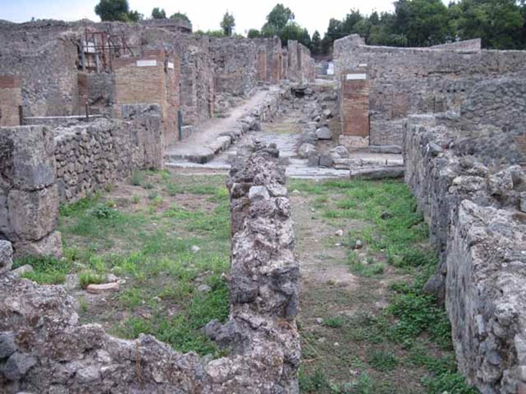 VIII.7.10 Pompeii. September 2010. 
Looking east along corridor from rear dormitory room, towards shop entrance on Via Stabiana, and Vicolo del Conciapelle, opposite.
Photo courtesy of Drew Baker.

