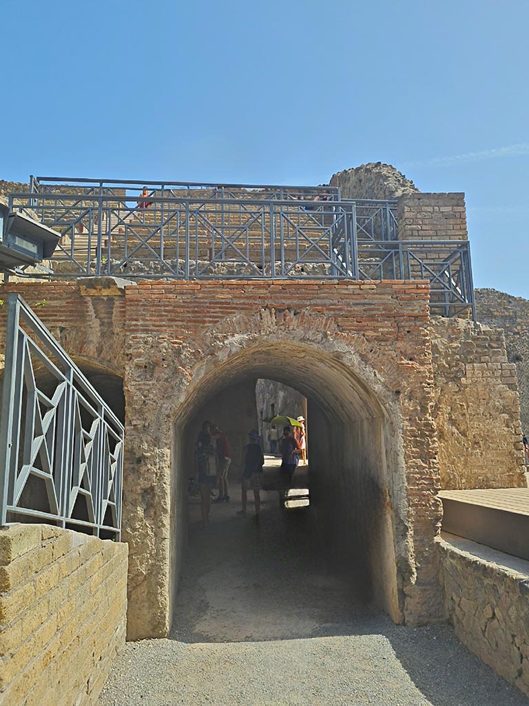 VIII.7.20 Pompeii. September 2024. 
Looking east through arch with tribunal above. Photo courtesy of Giuseppe Ciaramella.
