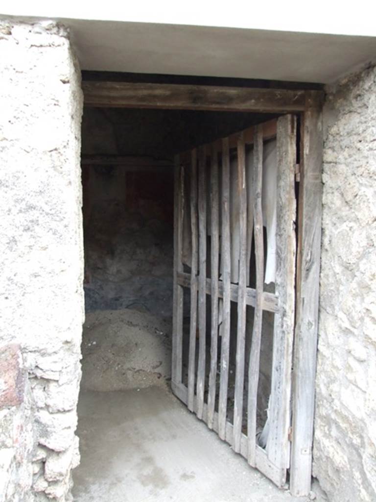 IX.2.10 Pompeii. December 2007. Doorway to cubiculum on south side of peristyle.
According to PPP, in this cubiculum the zoccolo was painted black with panels, and the middle zone of the walls would have been painted red. On the south wall, the central panel was azure blue with the painting of Galatea and Polyphemus (30 x 30).
See Bragantini, de Vos, Badoni, 1986. Pitture e Pavimenti di Pompei, Parte 3. Rome: ICCD. (p.410)
According to Fiorelli, remaining painted in this room were a group of flying Cupids and Psyches, and a figure of a naked Galatea, seen from her shoulders, embracing and joining to Polyphemus, sitting on a rock.
See Fiorelli, G, (1875). Descrizione di Pompei, (p.380).
According to Sogliano, the paintings found here would have been – Eros & Psyche (no.397) and Flying Eros & Psyche (no.398) both on a red background in the cubiculum under the south portico of garden. Galatea, (but nearly destroyed) (no.475).
See Sogliano, A., 1879. Le pitture murali campane scoverte negli anni 1867-79. Napoli: Giannini. (p.68 and p.79)

Also according to Sogliano, from the windowed cubiculum under the south portico of the garden, the following painting was seen – Female crowned figure, with a plate in her left hand, from which it seemed she was taking something with her right hand, (0.29 high red monochrome on yellow background) (no.825, p.159).  (Note: this may or may not be from this particular room).
See Sogliano, A., 1879. Le pitture murali campane scoverte negli anni 1867-79. Napoli: Giannini. (p.159)

For description of the upper zone of the wall in this cubiculum, 
See Pompejanische Kopien aus Danemark, SAP No. 24, by M.Staub Gierow. (p.231, cat 276) 
