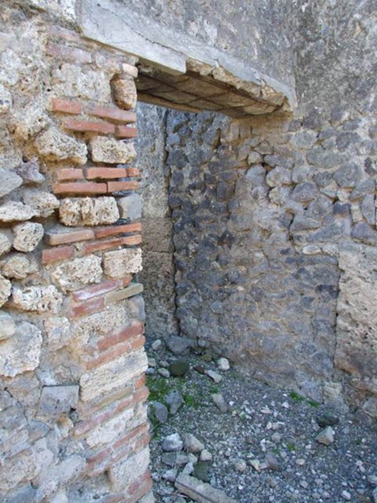 IX.9.d Pompeii. March 2009. Doorway to rooms h and i.  
Room with stairs to upper floor, and latrine underneath.
On the left of the doorway, on the wall of the atrium, a graffito was found. It read  
CTXXXV
PLXXXVII
