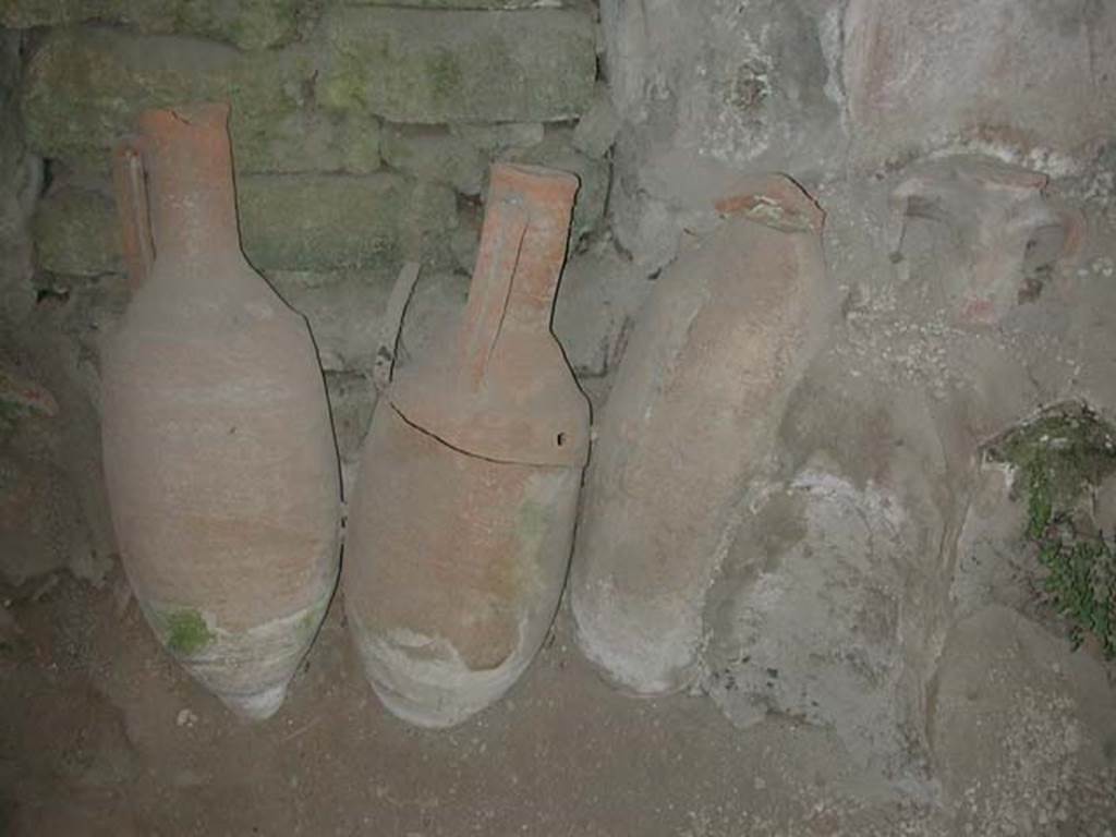 IX.11.2 Pompeii. September 2003. Amphorae in front of blocked door at centre of east wall. Photo courtesy of Nicolas Monteix.