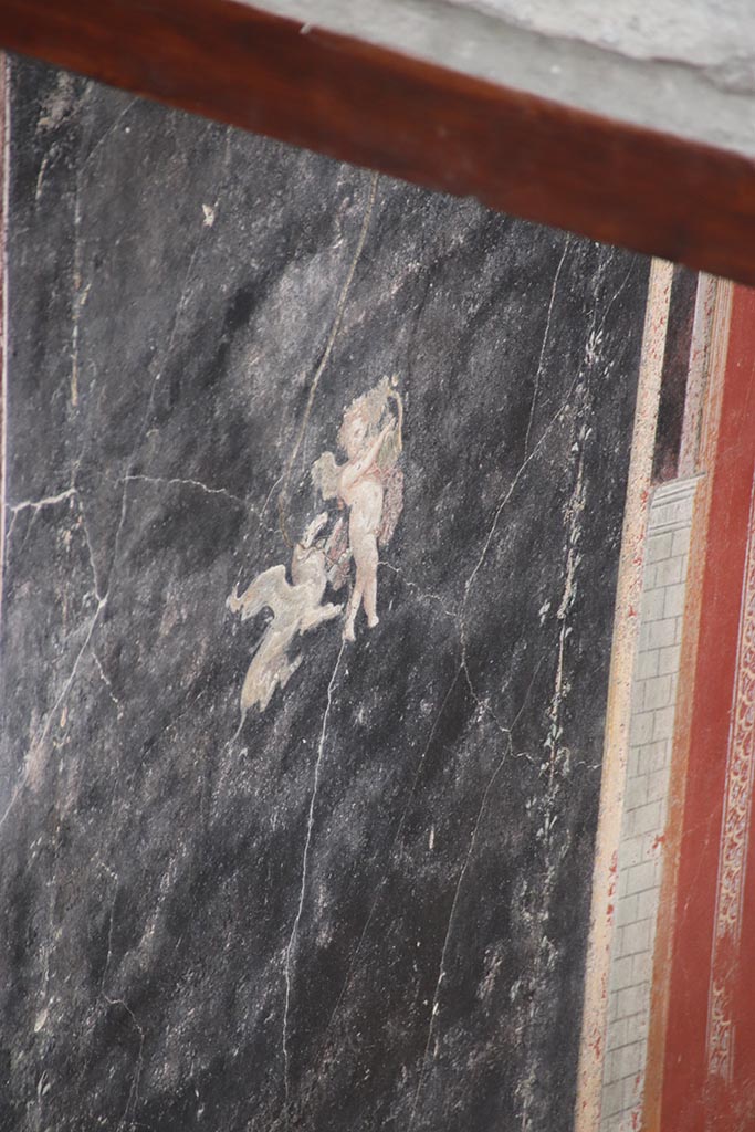 IX.12.A/IX.12.9 Pompeii. October 2024. 
Room 18, north wall, detail of painted Cupid. Photo courtesy of Klaus Heese.
