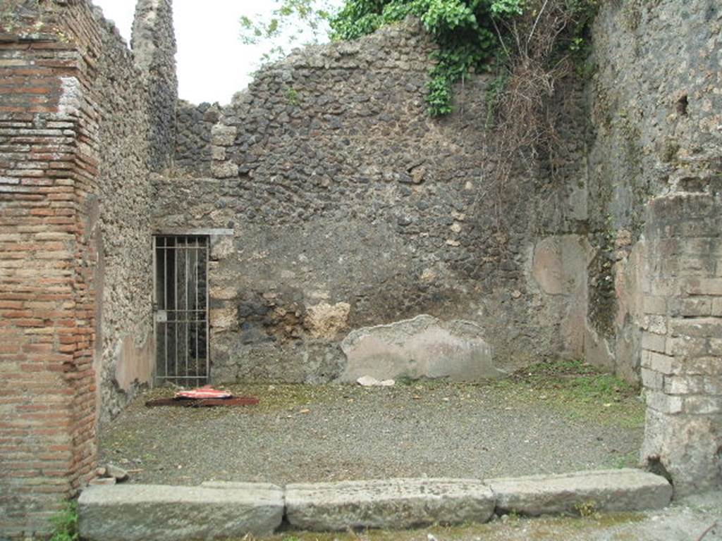IX.14.1 Pompeii. May 2005. Entrance.  According to Della Corte, at the rear of this shop were two small and rustic rooms, and a deep well. When found the well was empty of earth but was not explored because of the mofeta, or gas. See Notizie degli Scavi, 1911, (p.351), for excavations of September 1911.


 
