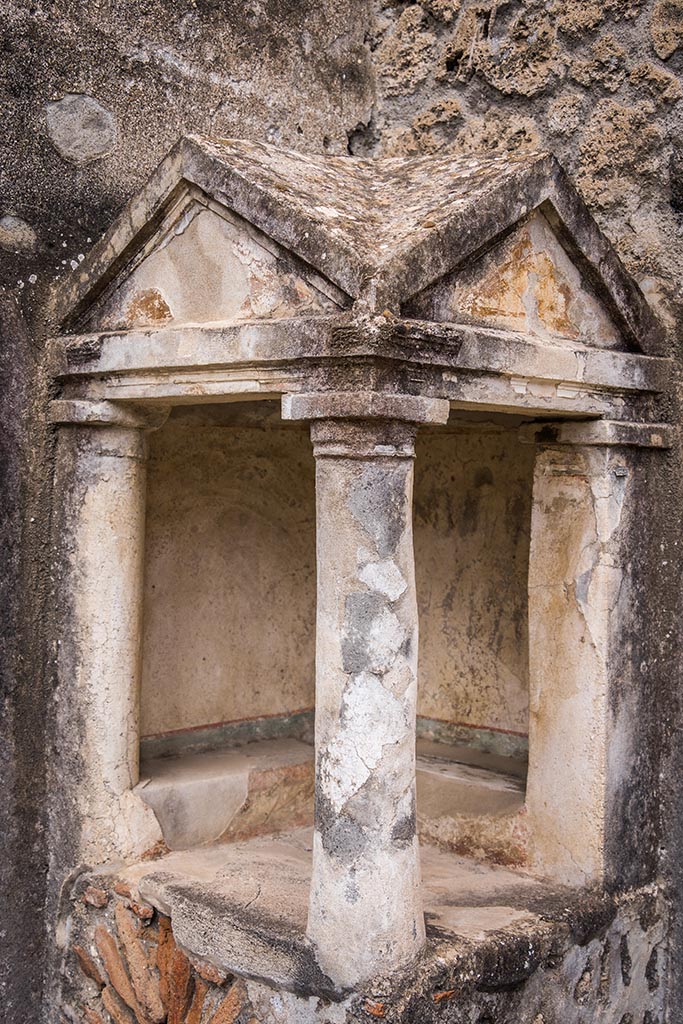 IX.14.4 Pompeii. July 2024. 
Household lararium shrine 32. Detail of rear walls, columns and pediment. 
Photo courtesy of Johannes Eber.
