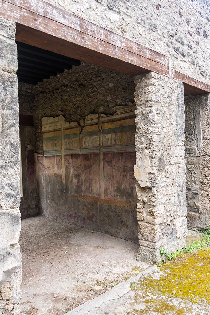 IX.14.4 Pompeii. July 2024. 
Looking south along west wall of tablinum from atrium of IX.14.2. Photo courtesy of Johannes Eber.
