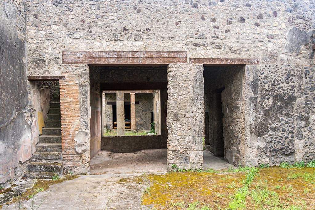 IX.14.4 Pompeii. July 2024. 
Room 27, the secondary atrium at IX.14.2, looking south towards staircase, tablinum 19 and corridor. Photo courtesy of Johannes Eber.
