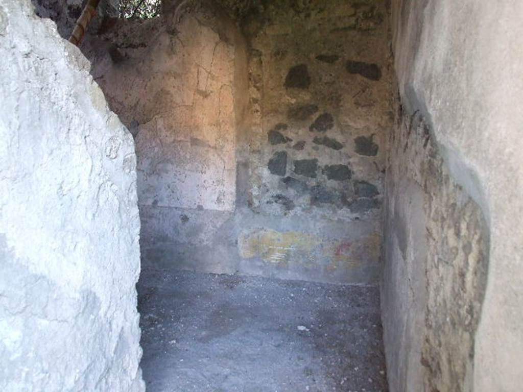 HGW24 Pompeii. December 2006. Looking south along small corridor, now blocked at its southern end. In the left wall, would have been a doorway into a room with three windows overlooking the garden, not yet excavated. This corridor and room are in the south-east corner of the peristyle. 

