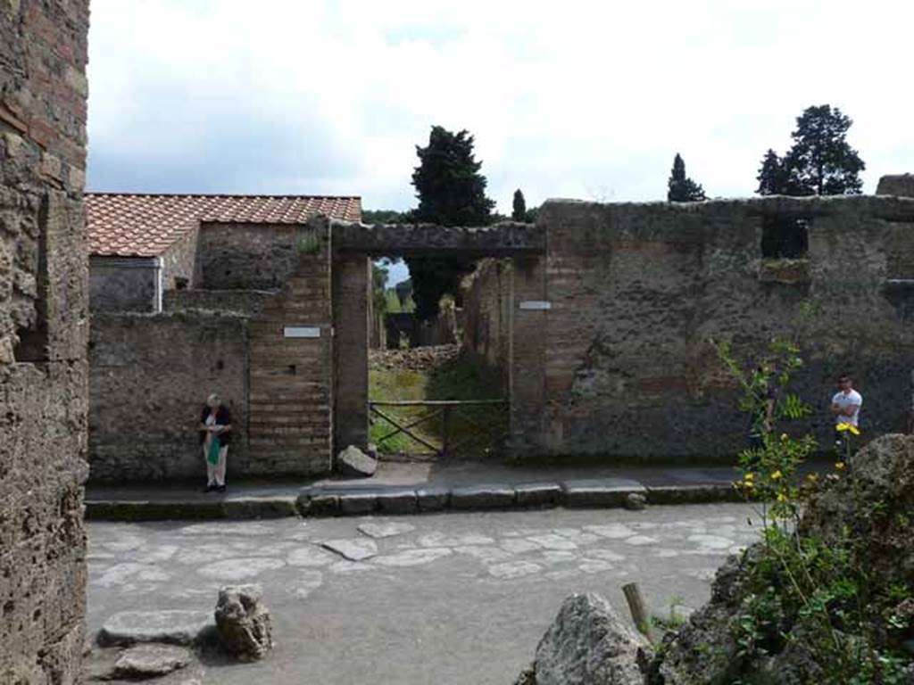 Via dell’Abbondanza, south side. May 2010. Looking across junction to Vicolo della Venere, between II.3 and II.2