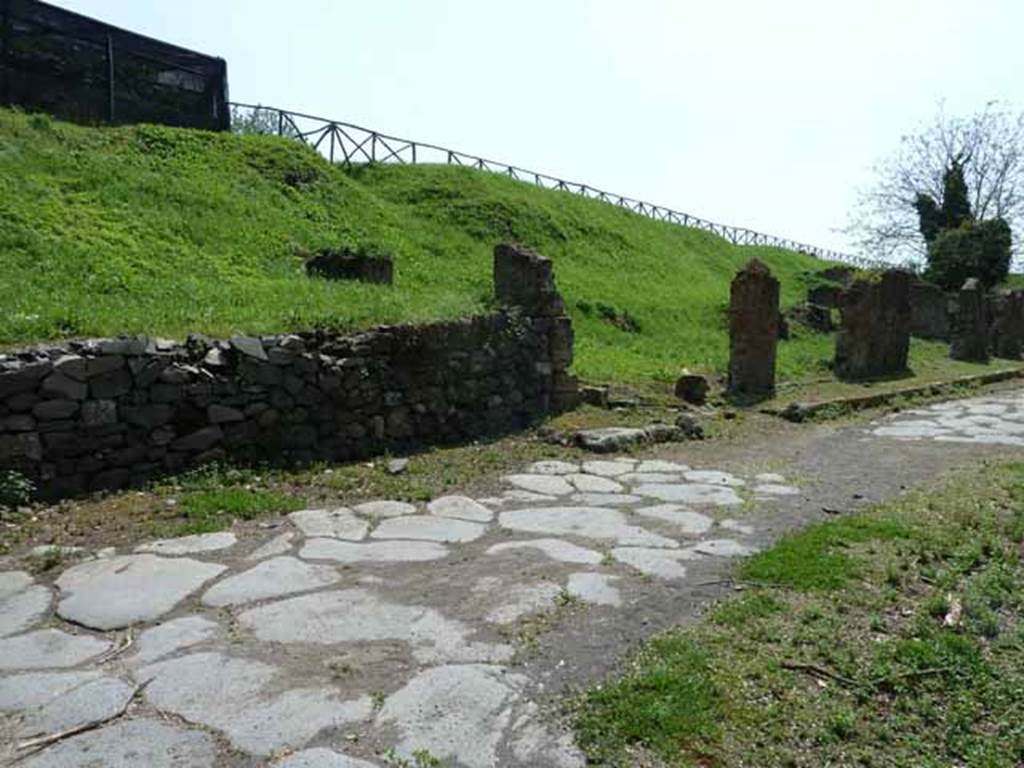 Via di Nola, south side, May 2010.  Looking west along site of III.12 (behind modern wall) and III.11.