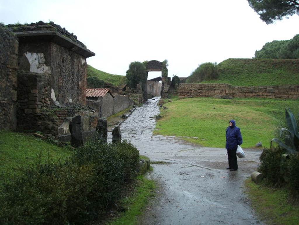 Pompeii Porta Nocera. December 2004. Tomb on south side of Via delle Tombe. Looking north to Porta Nocera.