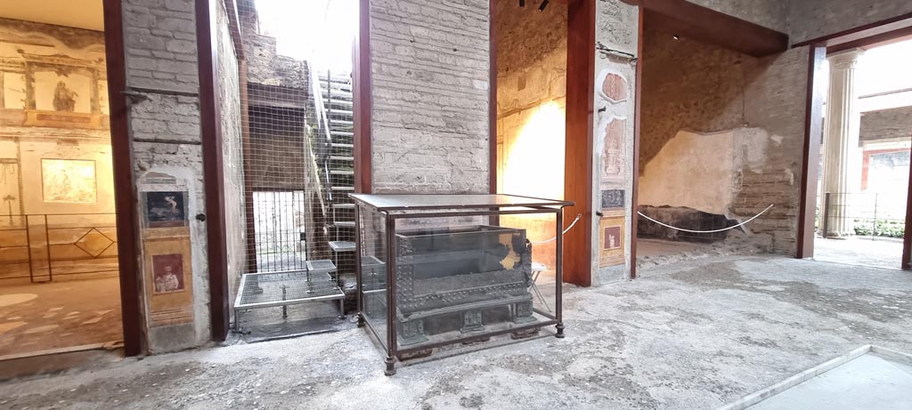 VI.15.1 Pompeii. January 2023. 
Looking south across atrium with strongbox/money box/safe, in centre. 
The statue of Priapus in the south ala, on the right, has been moved to the peristyle. Photo courtesy of Miriam Colomer.


