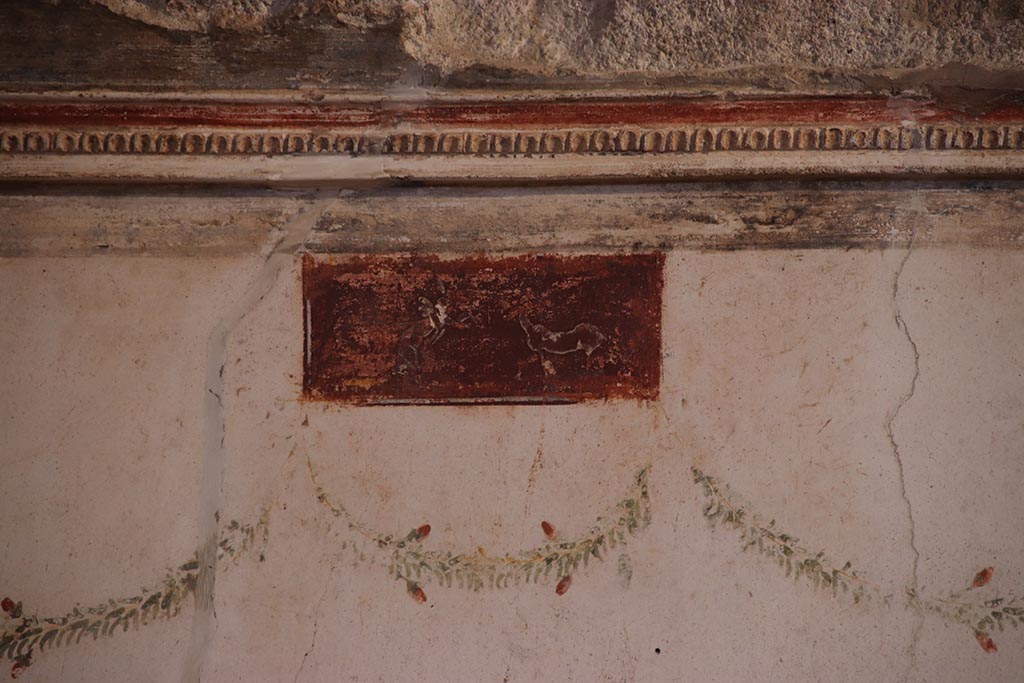 VI.15.1 Pompeii. October 2024. Detail of small painted panel at south end of west wall. Photo courtesy of Klaus Heese. 