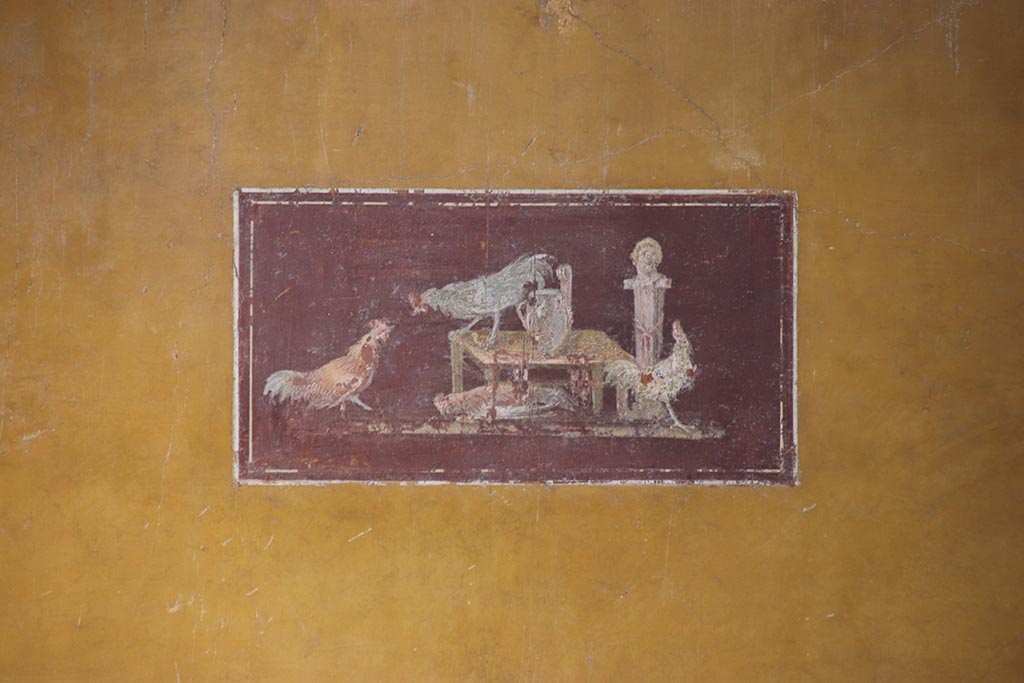 VI.15.1 Pompeii. October 2024. Painted panel of cocks from centre of south wall of ala h. Photo courtesy of Klaus Heese.