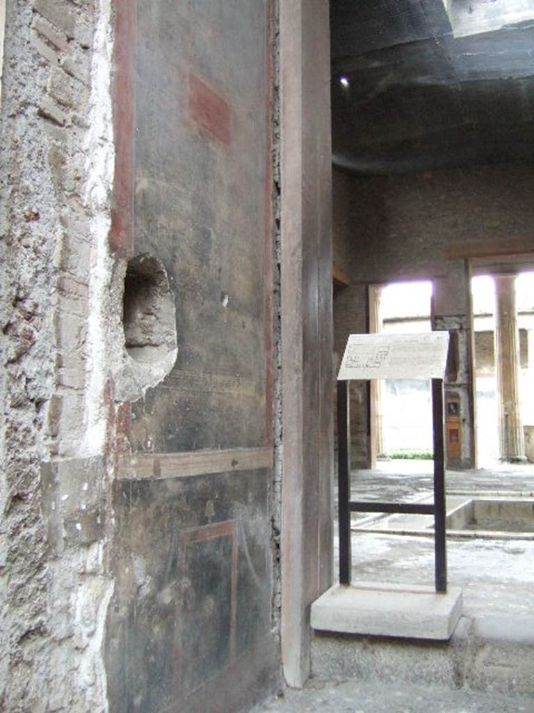 VI.15.1 Pompeii. December 2006. Left hand wall of vestibule.
According to Sogliano, on the south wall in the middle of a black panel was a rectangular panel (0.30 x 0.15m) on a red background, showing three cocks, of which two were fighting, and the third carried a branch in its beak.
See Sogliano A. La Casa dei Vettii in Monumenti Antichi VIII. Milan: Hoepli, p. 236.

