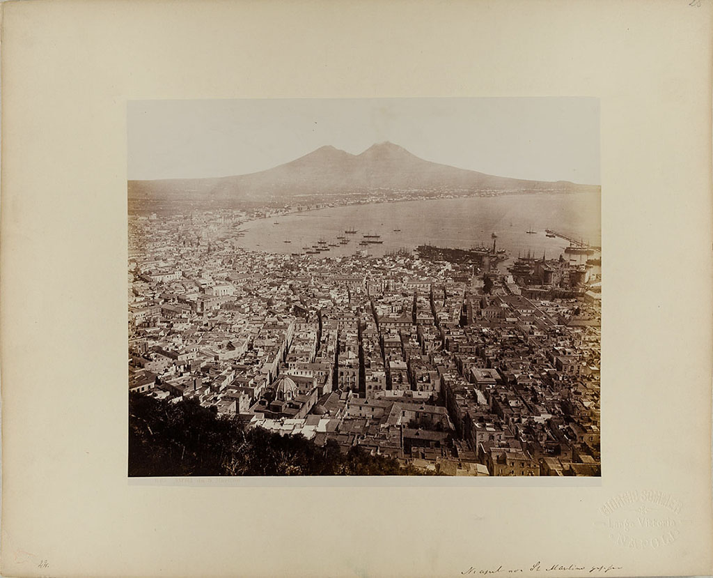 Vesuvius, 1860-1890. View of Naples from San Martino, with Vesuvius in the distance.
Photo title at bottom is “1103. NAPOLI da S. Martino” by G. Sommer Napoli. 
The handwritten note says “Neapel von St Martino gesehen”.
Museum für Kunst und Gewerbe Hamburg, inventory number P1981.417 (Public Domain).
See https://sammlungonline.mkg-hamburg.de/de/object/1103.-Napoli-da-S.-Martino/P1981.417/mkg-e00135775
